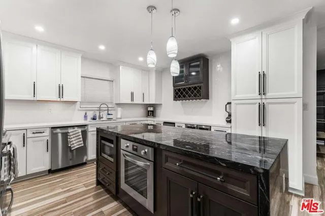 a kitchen with a sink a stove and cabinets