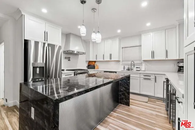 a kitchen with a refrigerator a sink and a stove