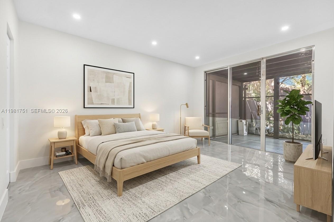 9332 Southwest 132nd Street Miami, FL 33176 - Photo 11 of 16 a bedroom with a large bed and a large window