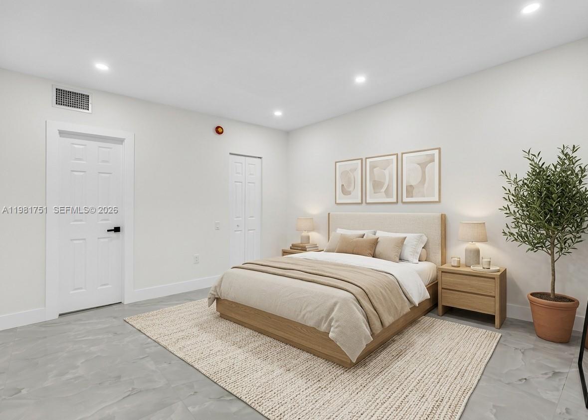 9332 Southwest 132nd Street Miami, FL 33176 - Photo 12 of 16 a spacious bedroom with a bed and a couch