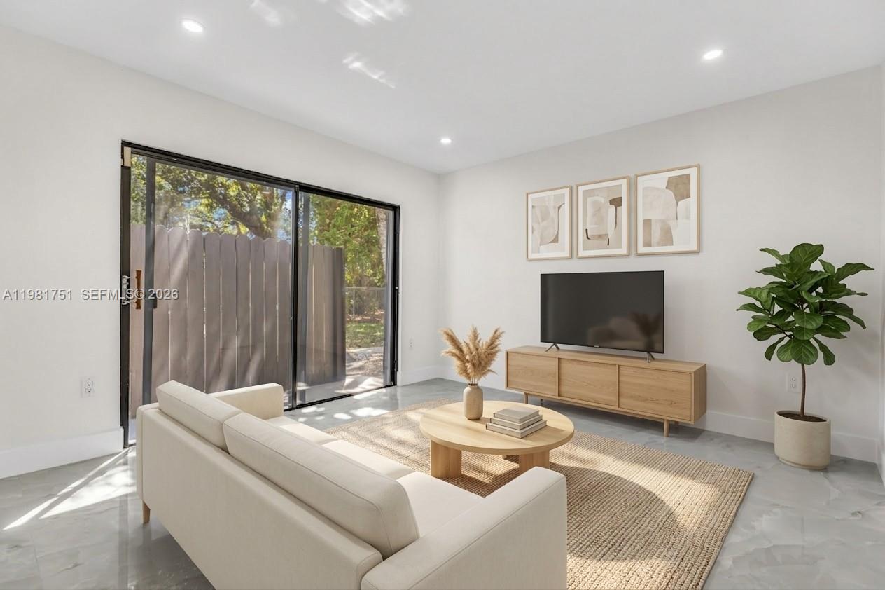 9332 Southwest 132nd Street Miami, FL 33176 - Photo 7 of 16 a living room with furniture and a flat screen tv
