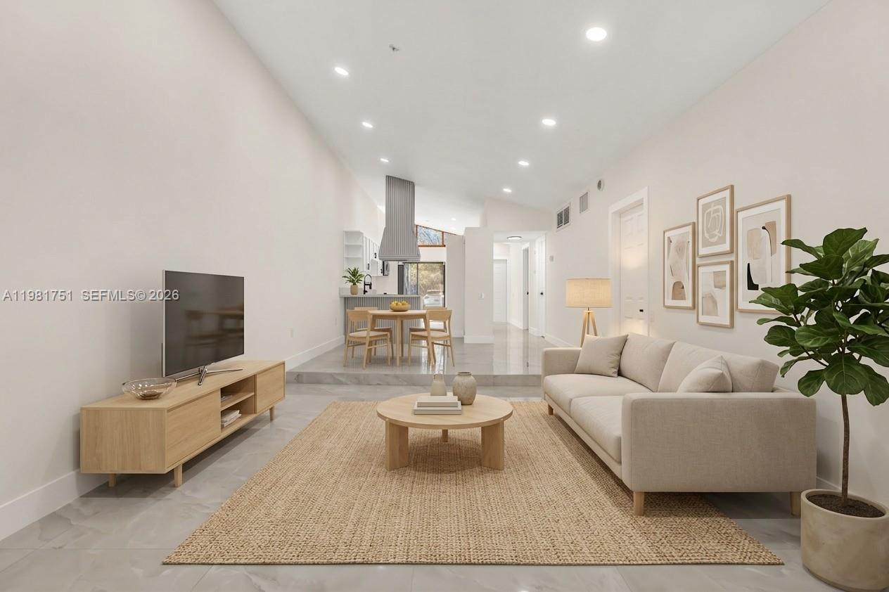 9332 Southwest 132nd Street Miami, FL 33176 - Photo 8 of 16 a living room with furniture and a flat screen tv