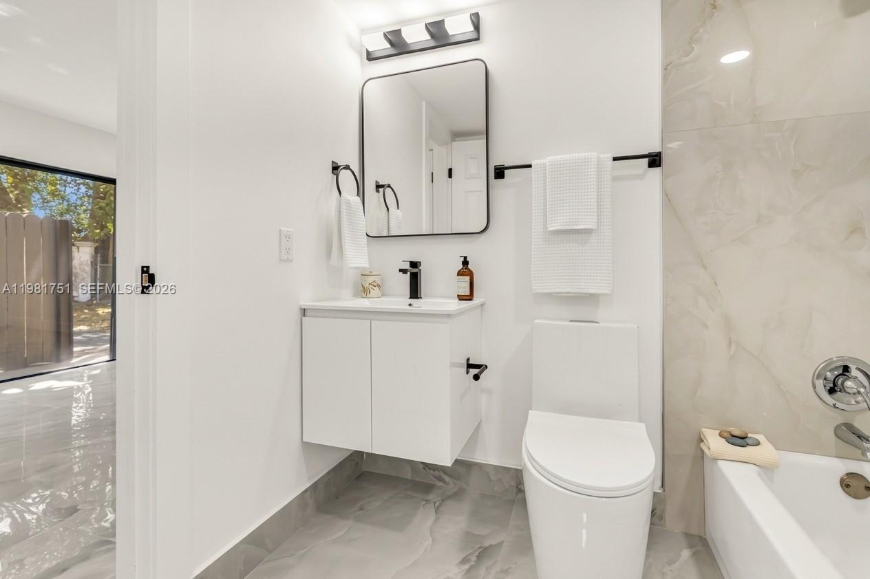 9332 Southwest 132nd Street Miami, FL 33176 - Photo 9 of 16 a bathroom with a toilet sink and shower