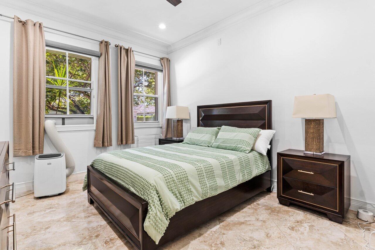 4023 Northwest 58th Street Boca Raton, FL 33496 - Photo 11 of 20 a bedroom with a bed and a fireplace