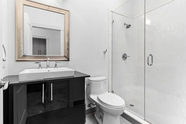 a bathroom with a sink toilet and shower