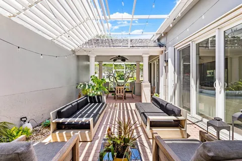 a view of a patio with table and chairs potted plants with wooden floor