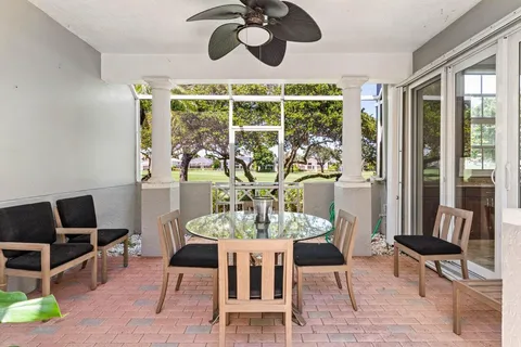 a view of a dining room with furniture a chandelier and wooden floor