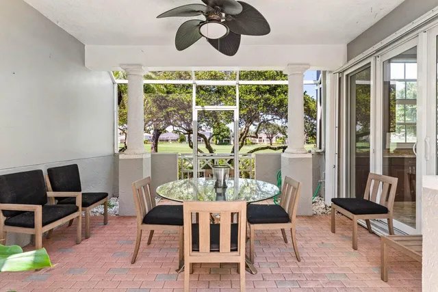 a view of a dining room with furniture a chandelier and wooden floor