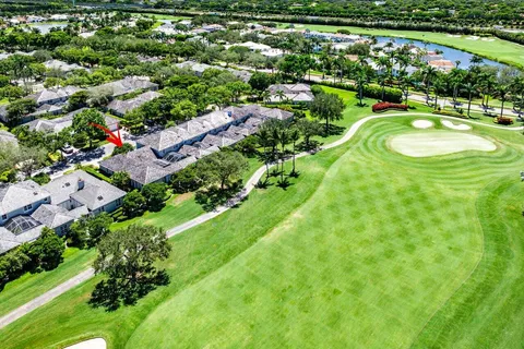 an aerial view of residential houses with outdoor space and trees