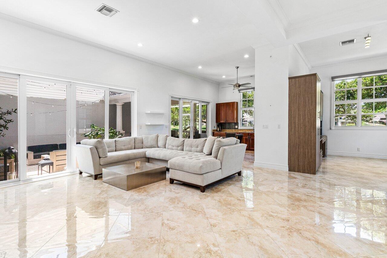 4023 Northwest 58th Street Boca Raton, FL 33496 - Photo 2 of 20 a living room with furniture and a large window