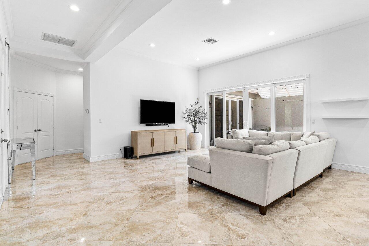 4023 Northwest 58th Street Boca Raton, FL 33496 - Photo 5 of 20 a living room with furniture and flat screen tv