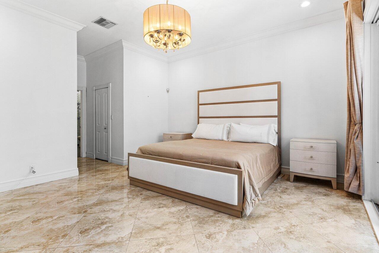 4023 Northwest 58th Street Boca Raton, FL 33496 - Photo 7 of 20 a bedroom with a bed and a window