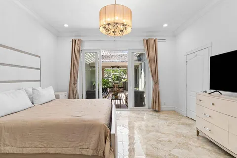 a bedroom with a bed and a flat screen tv