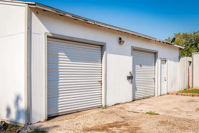 a bed room with a bed and a chair