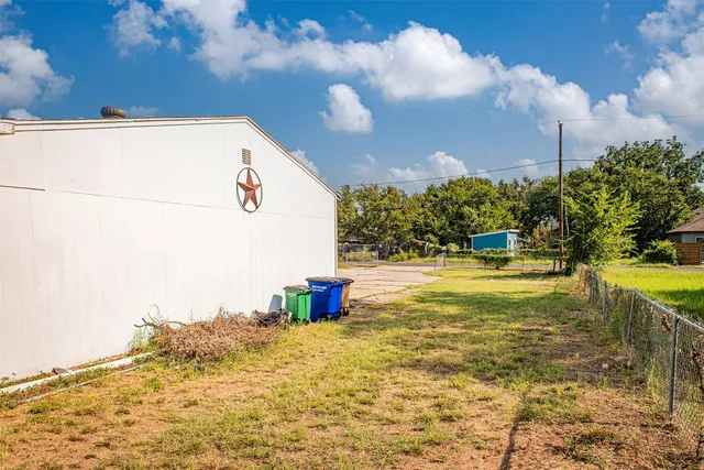 a view of yellow house with a yard