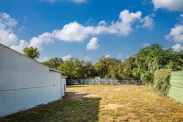 a big yard with large trees