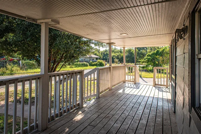 a view of a balcony with wooden floor