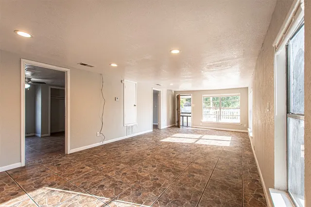 a kitchen with stainless steel appliances granite countertop a refrigerator a stove and a sink