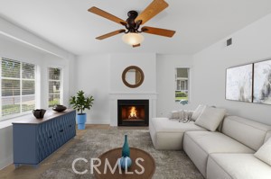 11 Fairside Irvine, CA 92614 - Photo 9 of 40 a living room with furniture a fireplace and a large window