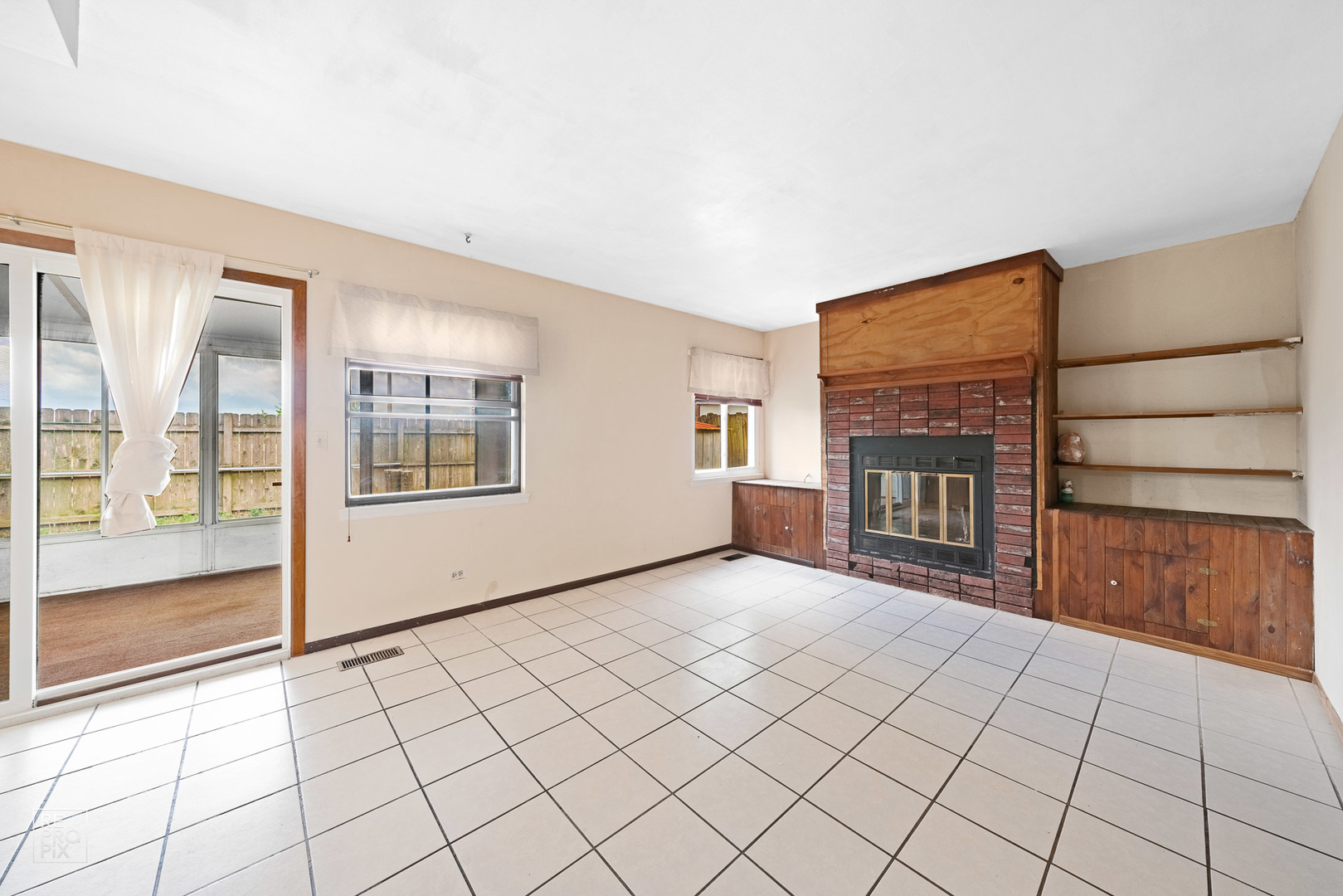 1901 Crescent Lane Hoffman Estates, IL 60169 - Photo 3 of 12 a view of an empty room with a fireplace and a window