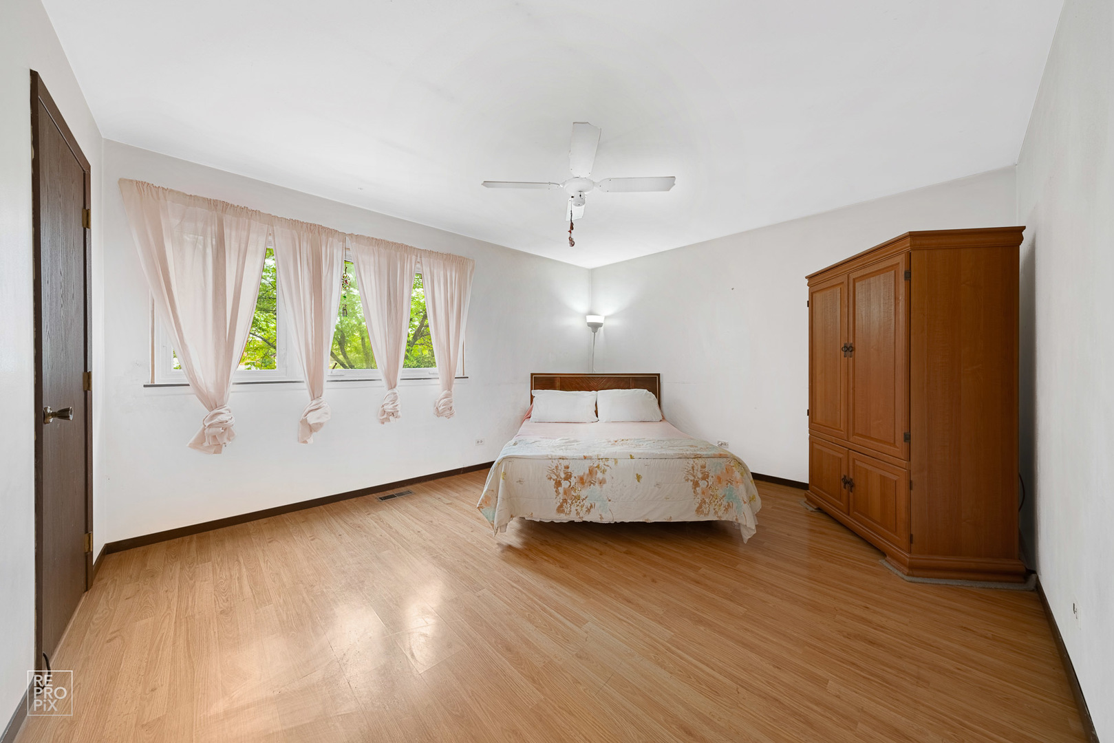 1901 Crescent Lane Hoffman Estates, IL 60169 - Photo 5 of 12 a spacious bedroom with a bed and wooden floor