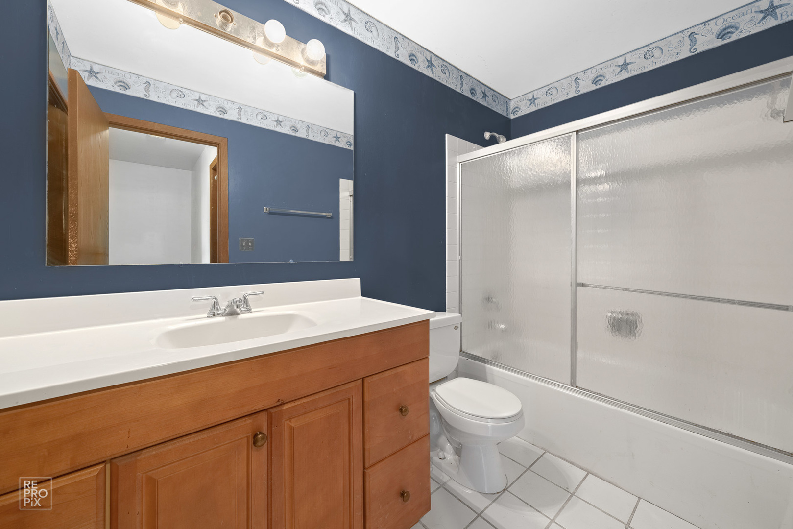1901 Crescent Lane Hoffman Estates, IL 60169 - Photo 7 of 12 a bathroom with a toilet a sink a mirror and a shower