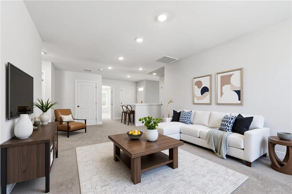 7565 Jennadee Drive Fairburn, GA 30213 - Photo 13 of 42 a living room with furniture and a flat screen tv