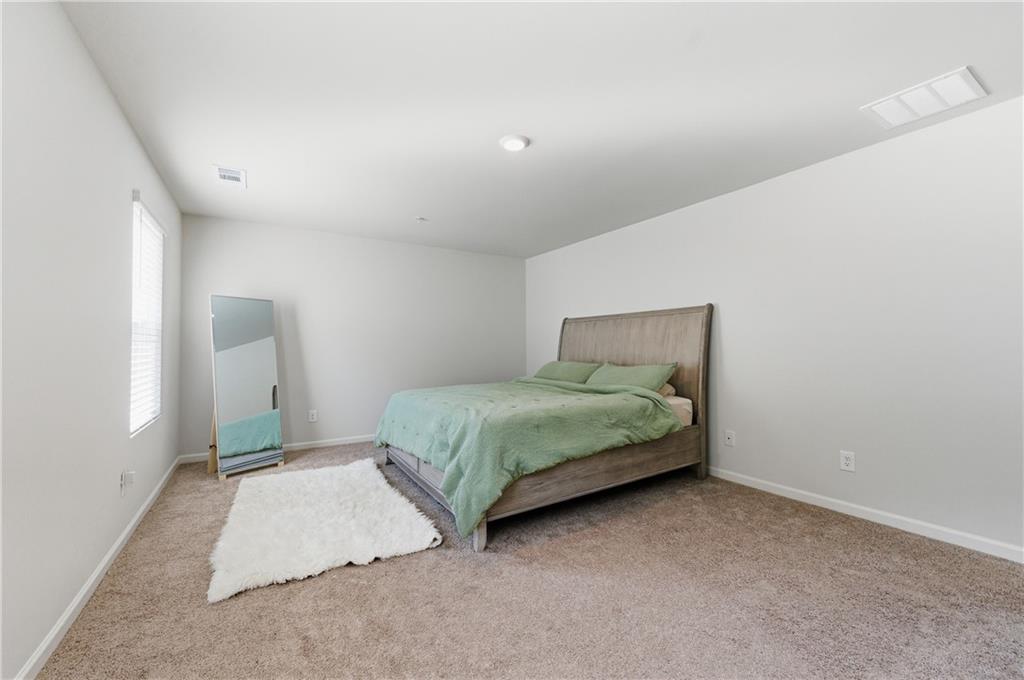 7565 Jennadee Drive Fairburn, GA 30213 - Photo 16 of 42 a bedroom with a bed and a window