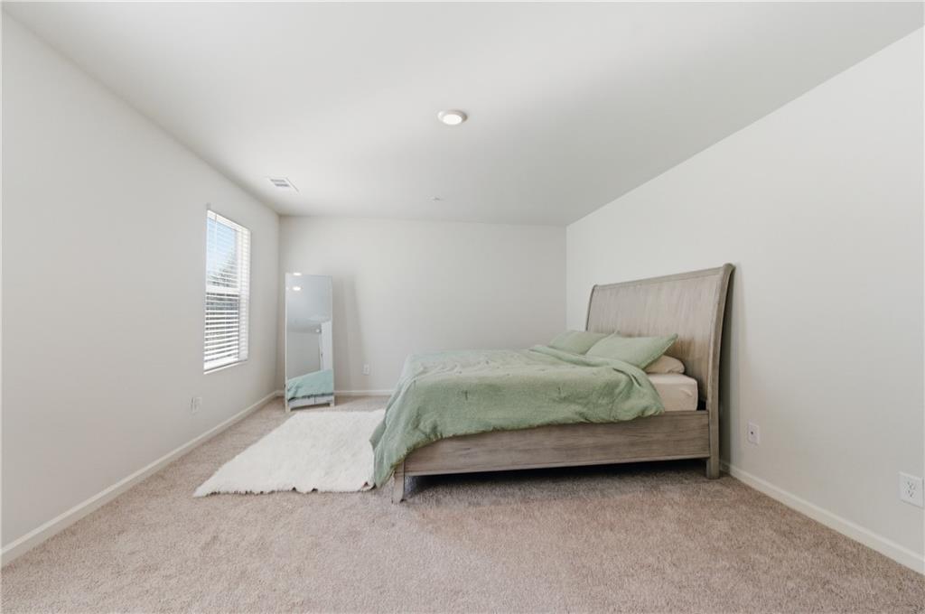 7565 Jennadee Drive Fairburn, GA 30213 - Photo 17 of 42 a bedroom with a bed and window