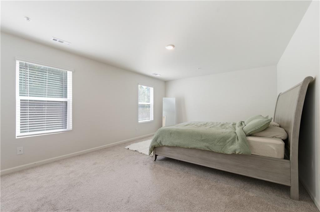 7565 Jennadee Drive Fairburn, GA 30213 - Photo 18 of 42 a spacious bedroom with a bed and a window