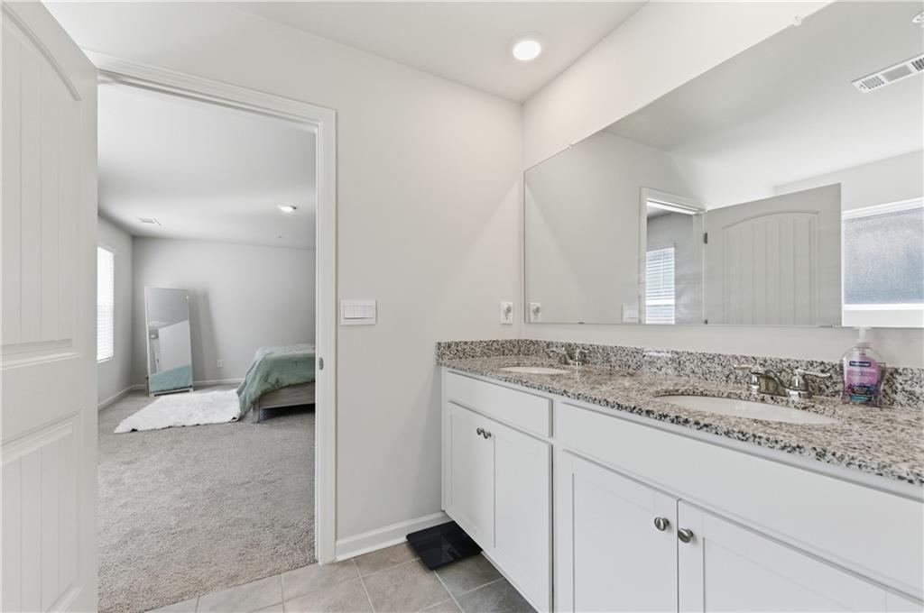 7565 Jennadee Drive Fairburn, GA 30213 - Photo 19 of 42 a bathroom with a sink and a mirror