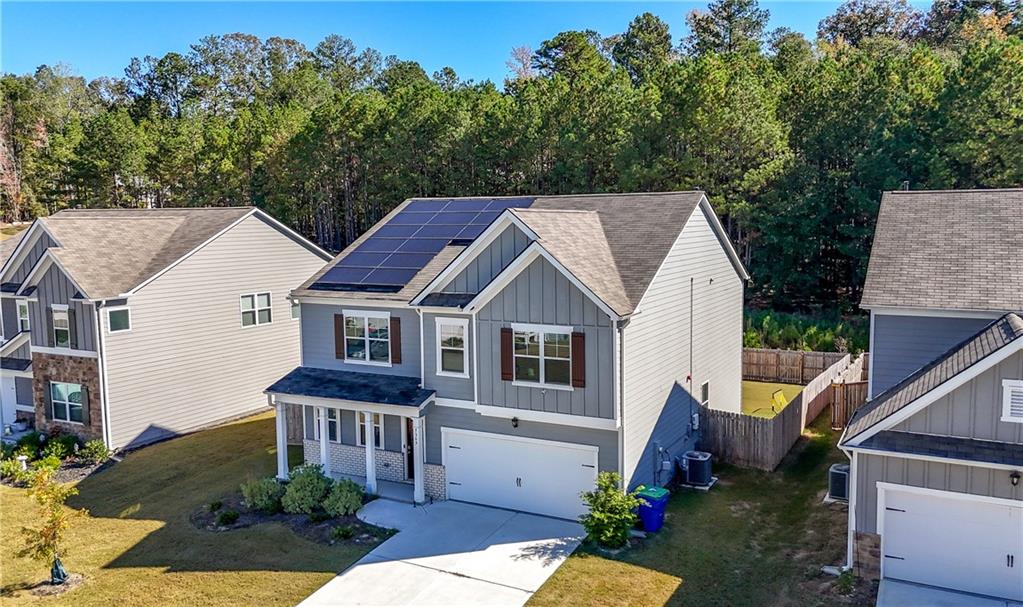 7565 Jennadee Drive Fairburn, GA 30213 - Photo 2 of 42 a view of a house with backyard and garden