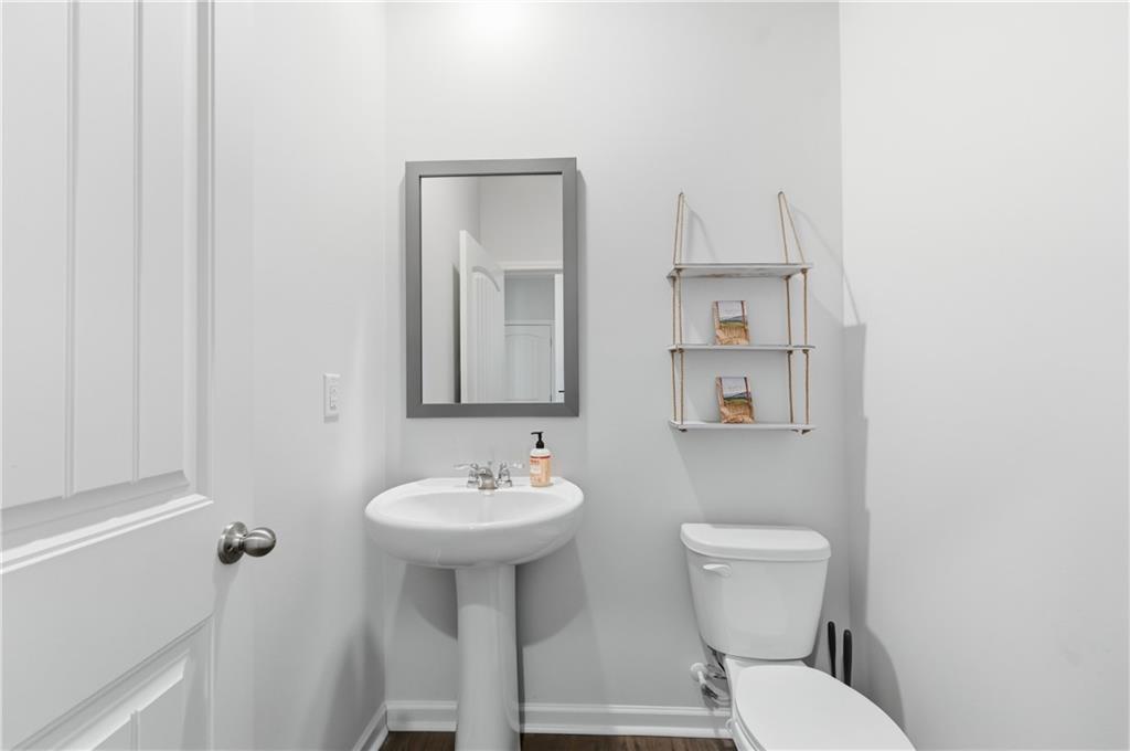 7565 Jennadee Drive Fairburn, GA 30213 - Photo 24 of 42 a bathroom with a sink toilet and mirror