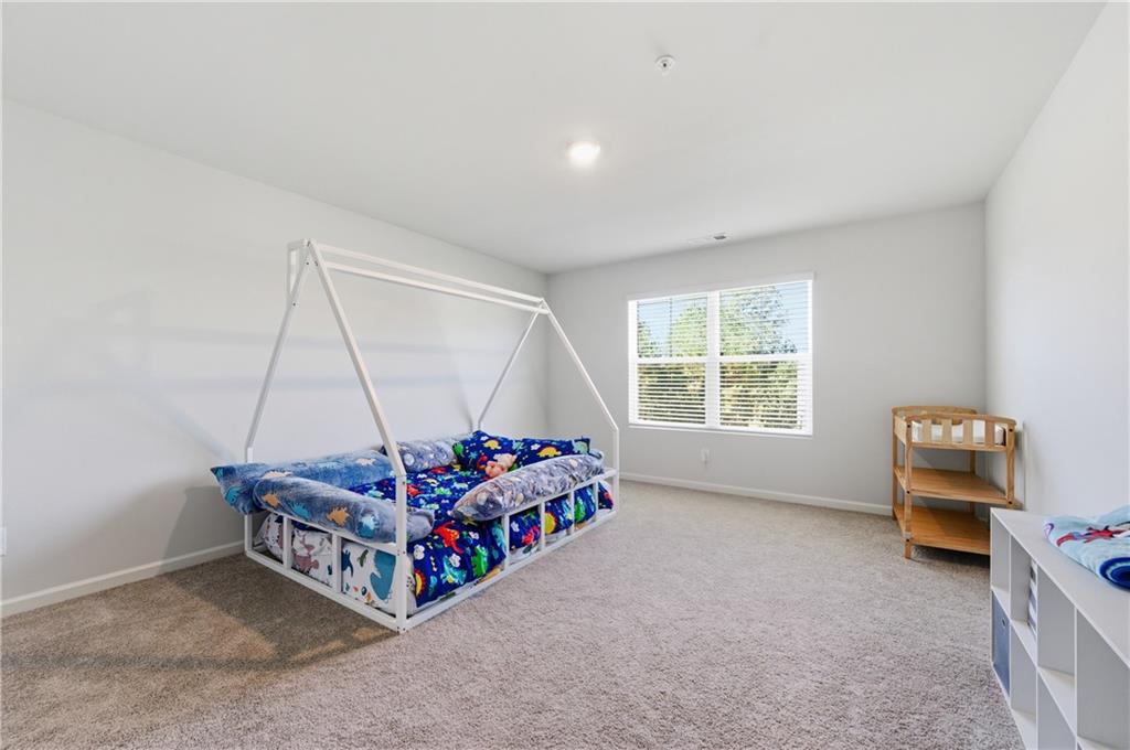 7565 Jennadee Drive Fairburn, GA 30213 - Photo 26 of 42 a room with a bed and a window