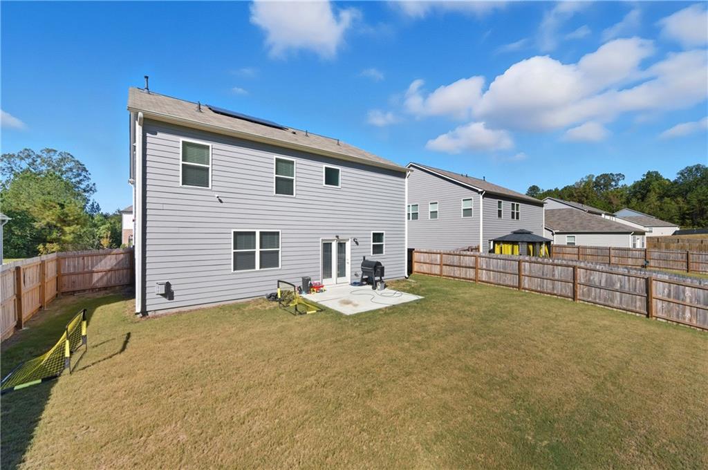 7565 Jennadee Drive Fairburn, GA 30213 - Photo 29 of 42 a view of a house with a backyard