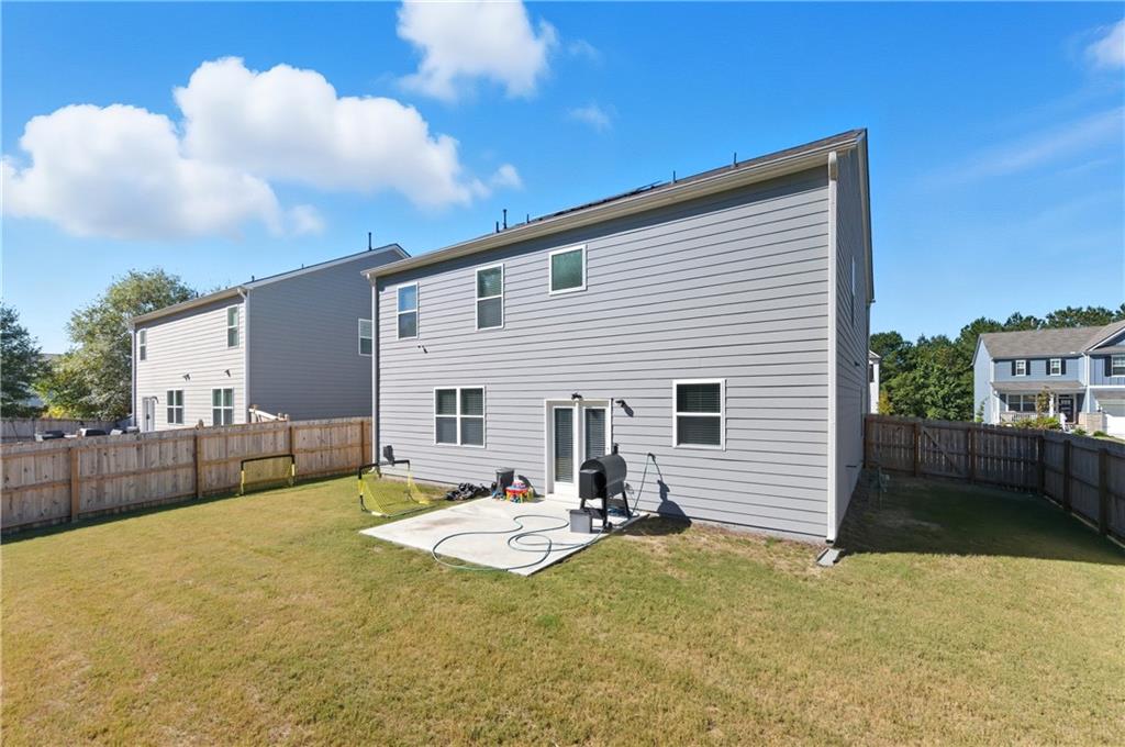 7565 Jennadee Drive Fairburn, GA 30213 - Photo 30 of 42 a view of a house with backyard and sitting area