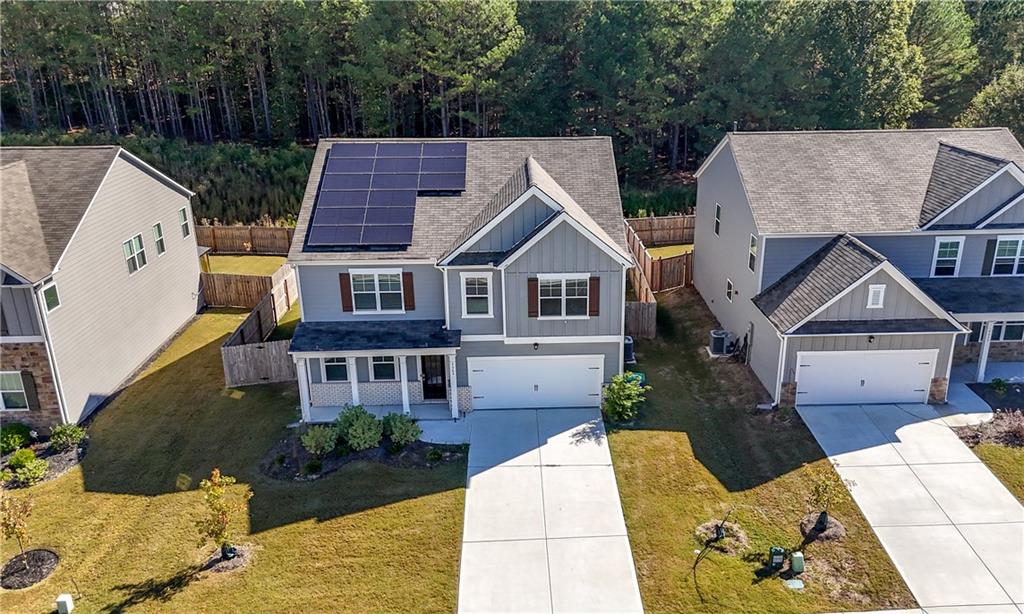 7565 Jennadee Drive Fairburn, GA 30213 - Photo 33 of 42 a aerial view of a house with a yard and potted plants