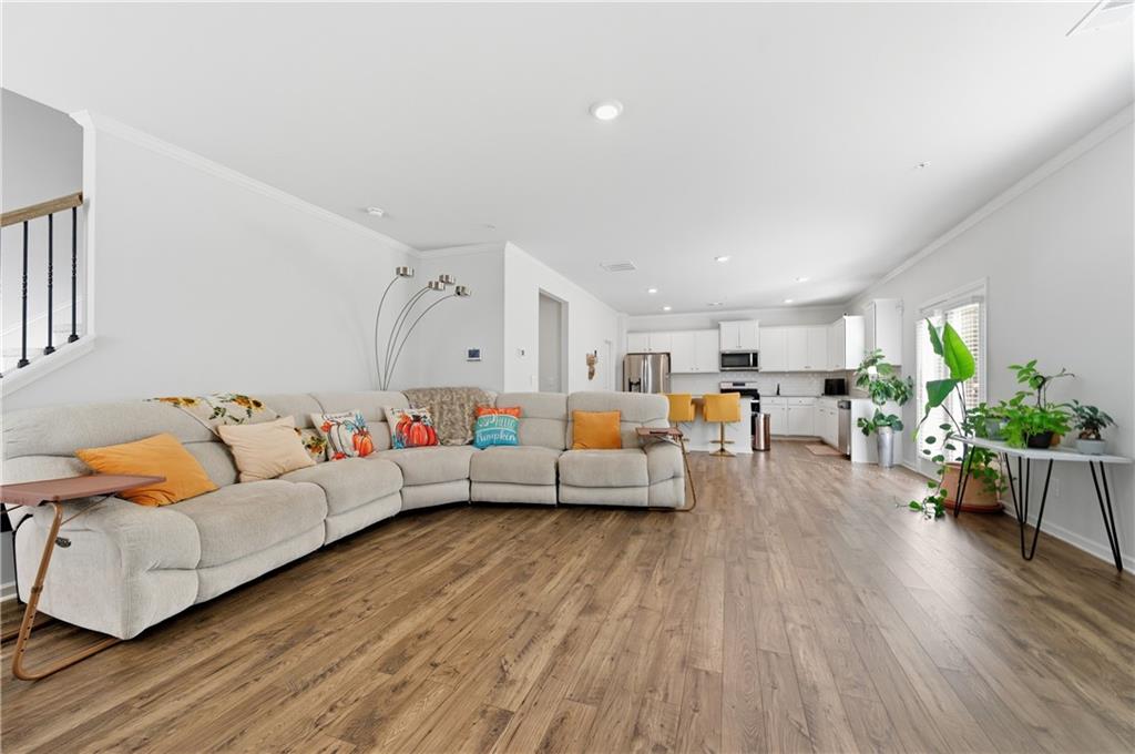 7565 Jennadee Drive Fairburn, GA 30213 - Photo 4 of 42 a living room with furniture and wooden floor