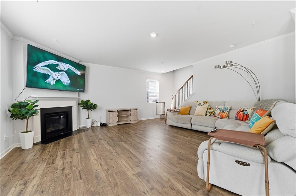 7565 Jennadee Drive Fairburn, GA 30213 - Photo 6 of 42 a living room with furniture and a fireplace
