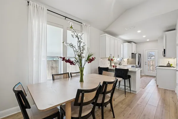 a view of a dining room with furniture and wooden floor