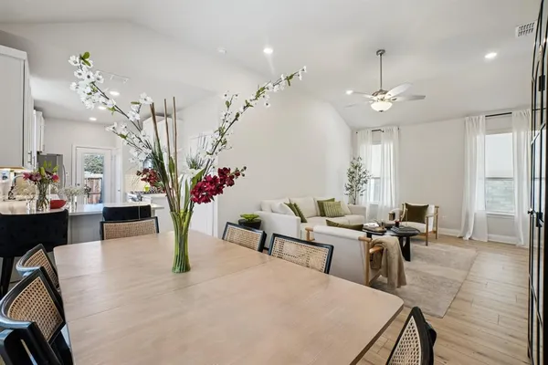 a living room with furniture potted plant and chandelier