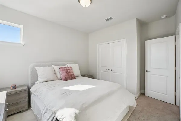 a bedroom with a bed and a closet