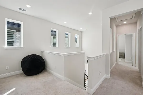 a view of a big room with windows and wardrobe