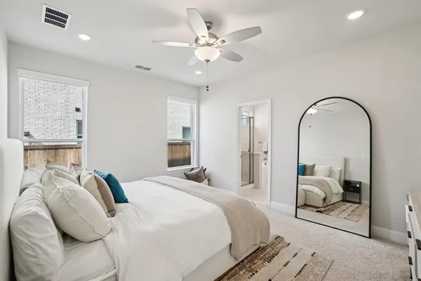 a bedroom with a bed and ceiling fan