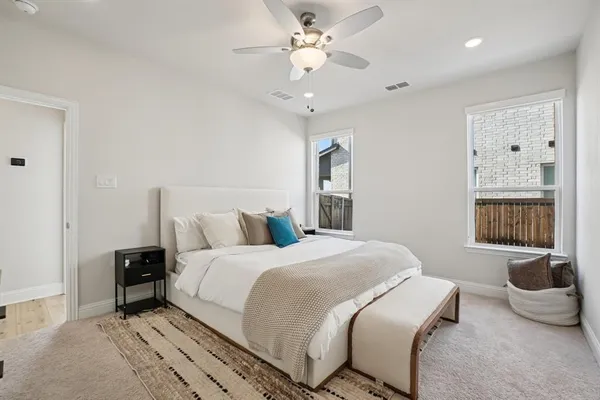 a bedroom with a large bed and a chandelier