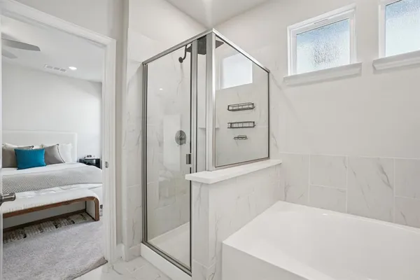 a bathroom with a bathtub and a shower