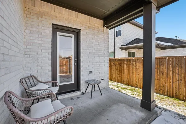 a view of a house with wooden fence