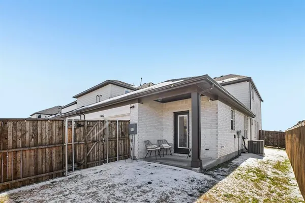 a front view of a house with a wooden fence