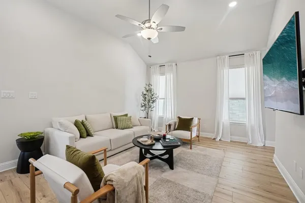 a living room with furniture and a chandelier