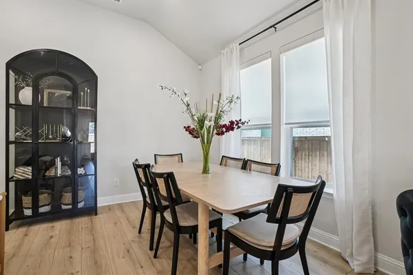 a view of a dining room with furniture and wooden floor